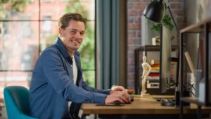 Professional translator working at desk with computer in modern office environment.