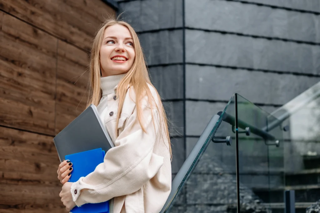 Professional woman holding certified translation documents and tablet outside modern office building.