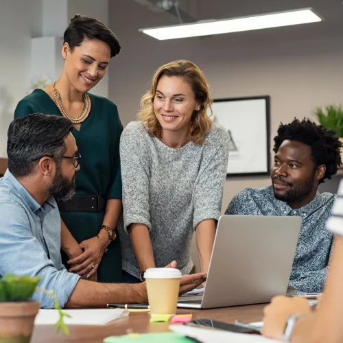 Diverse professional team collaborating on certified translation documents and projects in modern office setting.